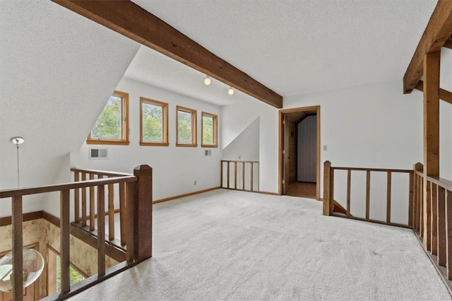 bonus room with visible vents, beam ceiling, baseboards, a textured ceiling, and carpet flooring