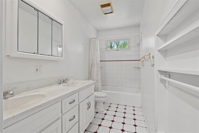 full bathroom with visible vents, a sink, double vanity, and toilet