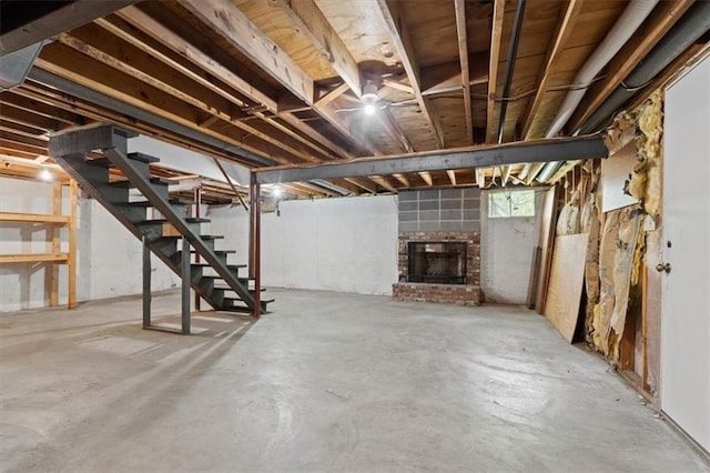 below grade area featuring stairs and a fireplace