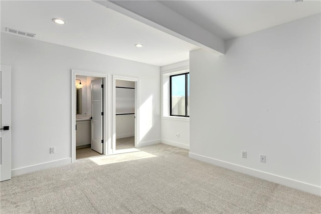 unfurnished bedroom with light carpet, baseboards, visible vents, and recessed lighting