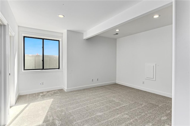 carpeted spare room with visible vents, baseboards, and recessed lighting