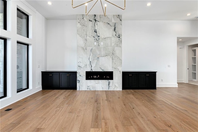 unfurnished living room featuring wood finished floors, recessed lighting, and a healthy amount of sunlight