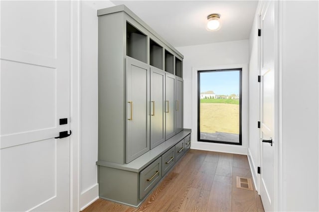 mudroom with visible vents, baseboards, and wood finished floors