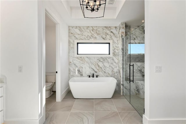 bathroom with a shower stall, a wealth of natural light, toilet, and a soaking tub