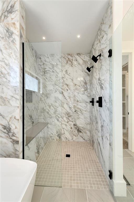 bathroom featuring a freestanding bath, marble finish floor, a marble finish shower, and recessed lighting