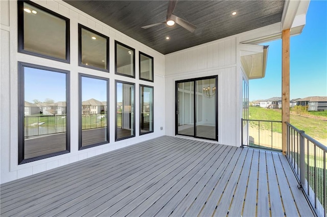 wooden deck with a ceiling fan and a residential view