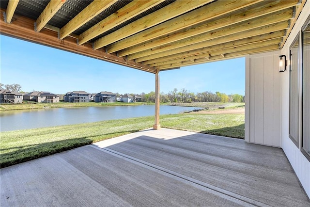 view of patio / terrace with a water view and a residential view