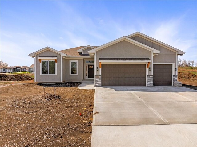 25016 W 89th Ter, Lenexa, KS 66227 - ranch-style house with an attached garage, driveway, stucco siding, and stone siding