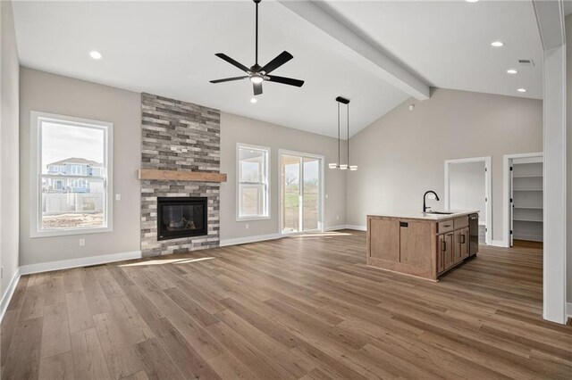 25016 W 89th Ter, Lenexa, KS 66227 - unfurnished living room featuring ceiling fan, wood finished floors, a large fireplace, and recessed lighting