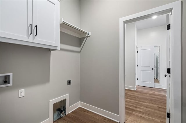 25016 W 89th Ter, Lenexa, KS 66227 - laundry area featuring hookup for an electric dryer, wood finished floors, cabinet space, and washer hookup