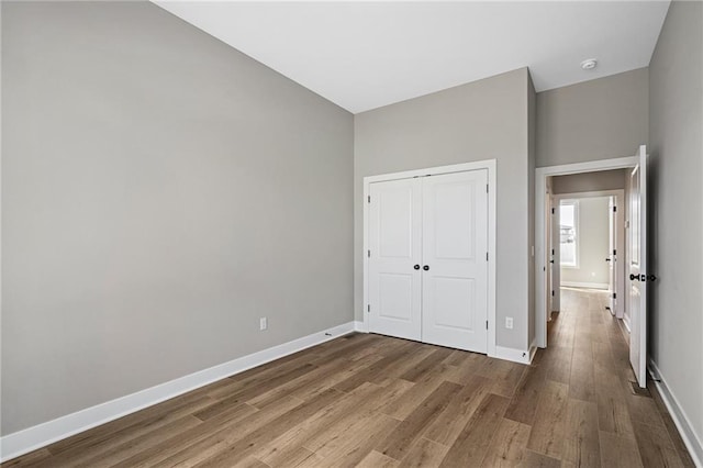25016 W 89th Ter, Lenexa, KS 66227 - unfurnished bedroom with wood finished floors and a closet