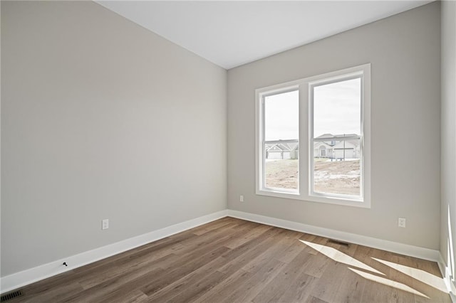 25016 W 89th Ter, Lenexa, KS 66227 - unfurnished room featuring baseboards and wood finished floors