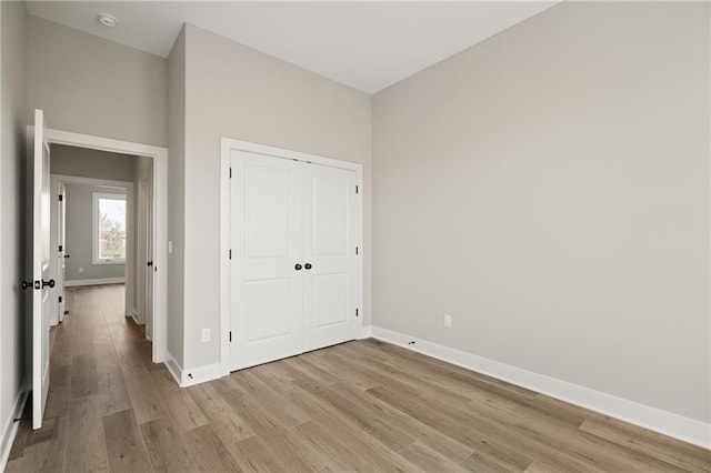 25016 W 89th Ter, Lenexa, KS 66227 - unfurnished bedroom with light wood-type flooring and a closet