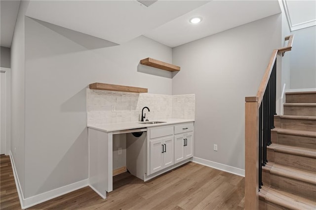 25016 W 89th Ter, Lenexa, KS 66227 - indoor bar with light wood-type flooring, backsplash, recessed lighting, and stairs
