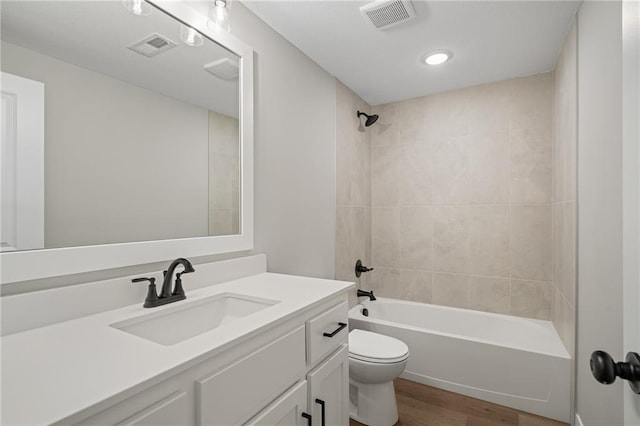 25016 W 89th Ter, Lenexa, KS 66227 - bathroom featuring wood finished floors, vanity, shower / bath combination, and recessed lighting