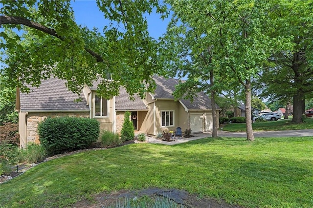 224 NW Locust St, Lees Summit, MO 64064 - view of front of house featuring a garage, driveway, stone siding, and a front yard