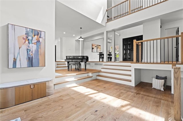 224 NW Locust St, Lees Summit, MO 64064 - stairway with wood finished floors, a towering ceiling, and recessed lighting