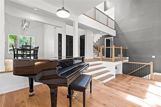 224 NW Locust St, Lees Summit, MO 64064 - staircase featuring wood finished floors and a high ceiling