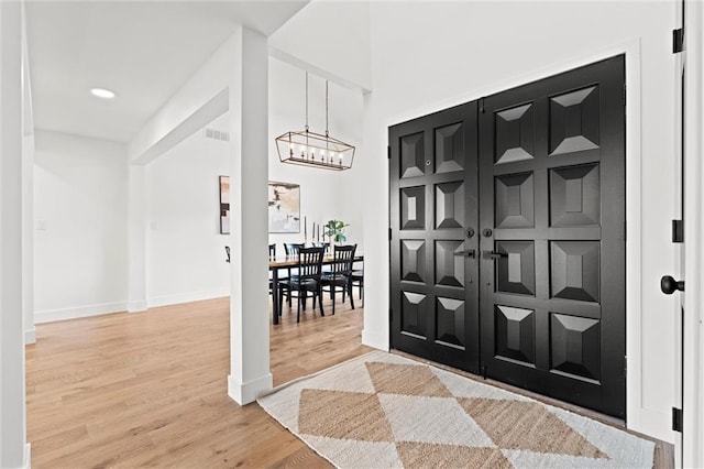 224 NW Locust St, Lees Summit, MO 64064 - entrance foyer with light wood-style flooring, a chandelier, and recessed lighting