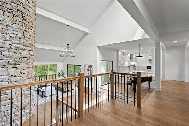 224 NW Locust St, Lees Summit, MO 64064 - hallway featuring wood finished floors, high vaulted ceiling, an upstairs landing, a chandelier, and beamed ceiling