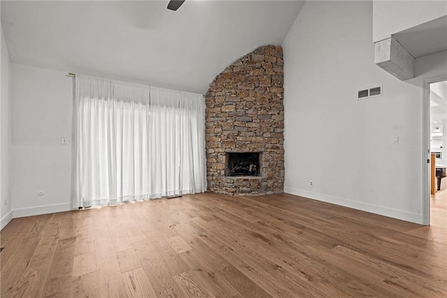 224 NW Locust St, Lees Summit, MO 64064 - unfurnished living room with a ceiling fan, lofted ceiling, wood finished floors, and a fireplace
