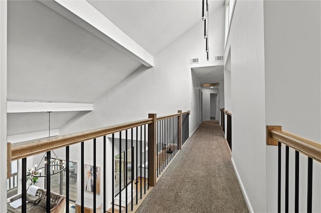 224 NW Locust St, Lees Summit, MO 64064 - hall with high vaulted ceiling, beam ceiling, carpet flooring, and a chandelier
