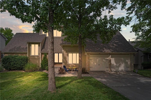 224 NW Locust St, Lees Summit, MO 64064 - view of front of property with driveway, a lawn, a garage, and a shingled roof