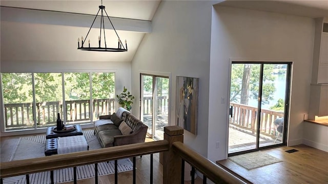 224 NW Locust St, Lees Summit, MO 64064 - living room with high vaulted ceiling, wood finished floors, and a chandelier