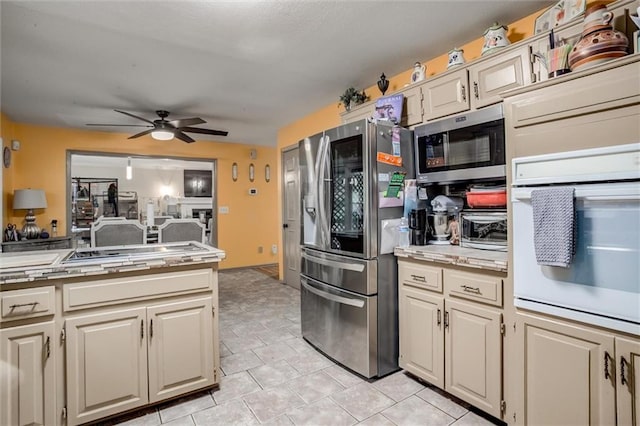 653 NE Reed Xing, Lees Summit, MO 64086 - kitchen featuring light countertops, a ceiling fan, stainless steel appliances, and a toaster