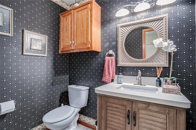 653 NE Reed Xing, Lees Summit, MO 64086 - half bathroom with vanity, toilet, and wallpapered walls