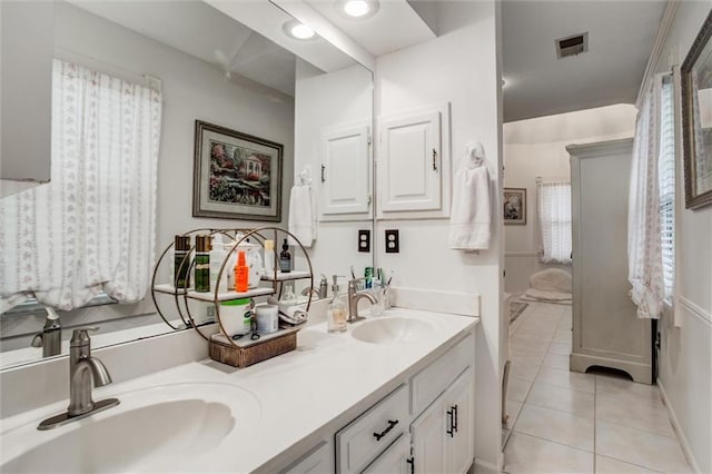 653 NE Reed Xing, Lees Summit, MO 64086 - bathroom featuring visible vents, a sink, tile patterned floors, and double vanity