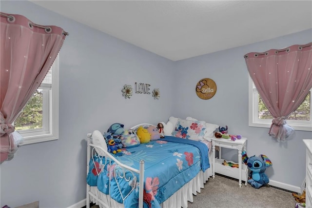 carpeted bedroom with multiple windows and baseboards
