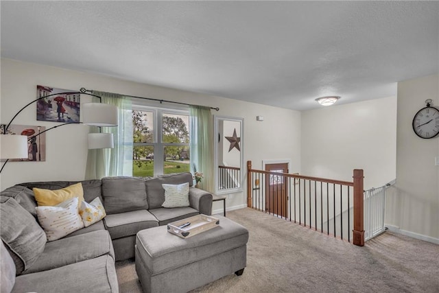 carpeted living area with a textured ceiling and baseboards