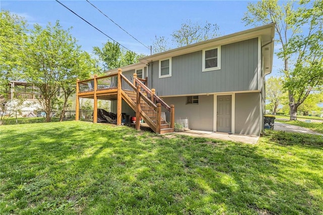back of property featuring stairs, a wooden deck, and a patio area