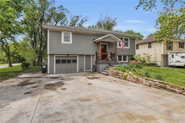 509 S Jackson St, Spring Hill, KS 66083 - bi-level home with an attached garage, a front lawn, and driveway