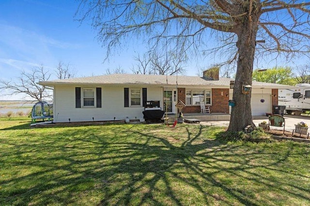 108 Sunrise Ct, Ozawkie, KS 66070 - rear view of house with a garage, a yard, and a trampoline
