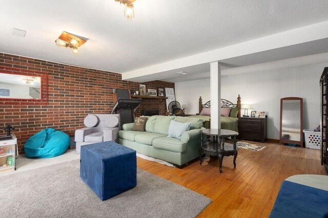 108 Sunrise Ct, Ozawkie, KS 66070 - living area with wood finished floors, a brick fireplace, and brick wall