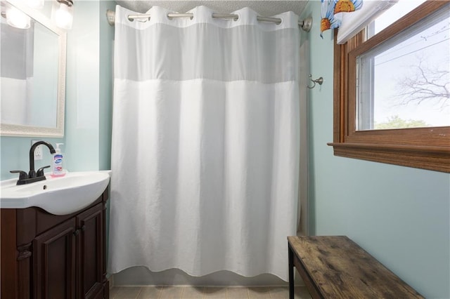 108 Sunrise Ct, Ozawkie, KS 66070 - bathroom featuring tile patterned floors, shower / bath combo with shower curtain, vanity, and a textured ceiling