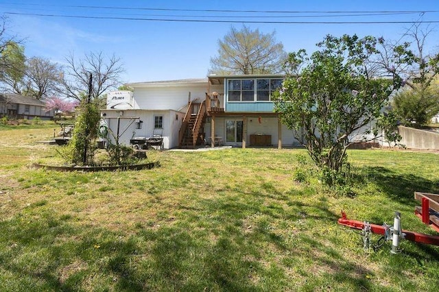 108 Sunrise Ct, Ozawkie, KS 66070 - rear view of house featuring stairs, fence, a wooden deck, a lawn, and a sunroom
