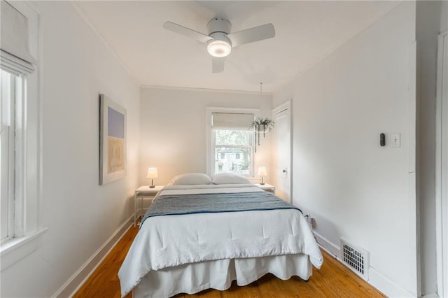 7235 Main St, Kansas City, MO 64114 - bedroom with wood finished floors, ceiling fan, and ornamental molding