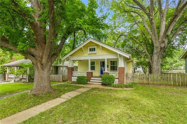 7235 Main St, Kansas City, MO 64114 - view of front of home with a porch and brick siding