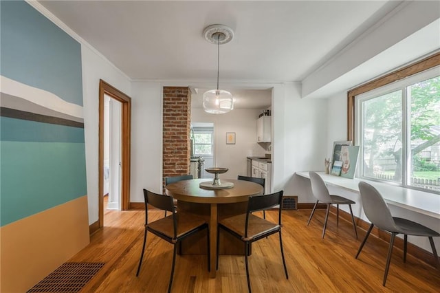 7235 Main St, Kansas City, MO 64114 - dining room featuring light wood finished floors and ornamental molding