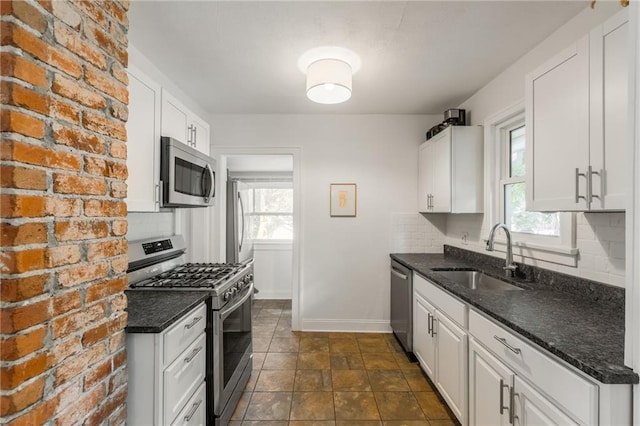 7235 Main St, Kansas City, MO 64114 - kitchen with appliances with stainless steel finishes, decorative backsplash, plenty of natural light, and white cabinetry