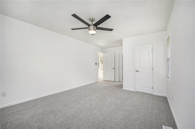 unfurnished bedroom with a textured ceiling, ceiling fan, carpet flooring, and baseboards