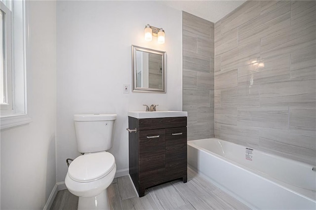 full bath with wood finished floors, vanity, toilet, and baseboards