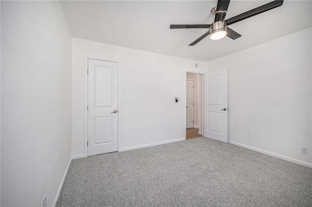 unfurnished bedroom with a ceiling fan, carpet flooring, and baseboards