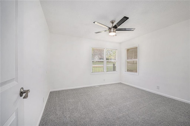 unfurnished room with baseboards, a ceiling fan, a textured ceiling, and carpet flooring