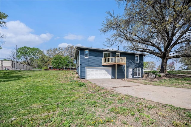 back of house featuring concrete driveway, a lawn, and a garage