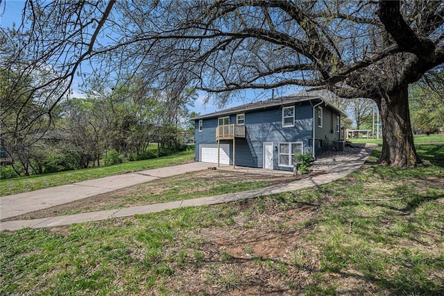 view of outdoor structure with concrete driveway and an attached garage