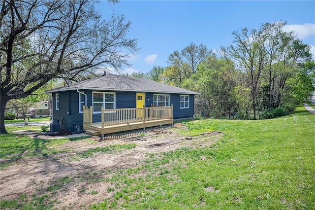 view of front of house with a wooden deck, a front lawn, and cooling unit